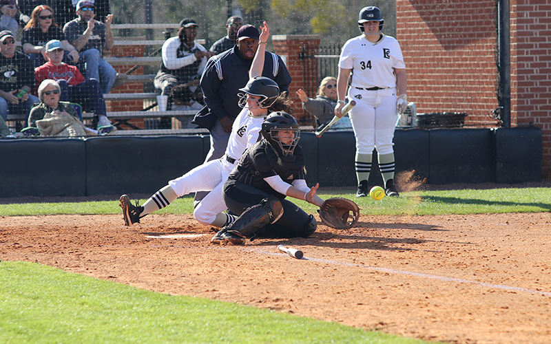 Lady Warrior sophomore catcher Anna McNeer scores ahead of the throw in action against Coastal Alabama-North. (EC Photo)